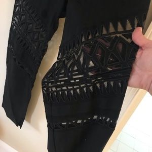 Black pant with see thu sections .